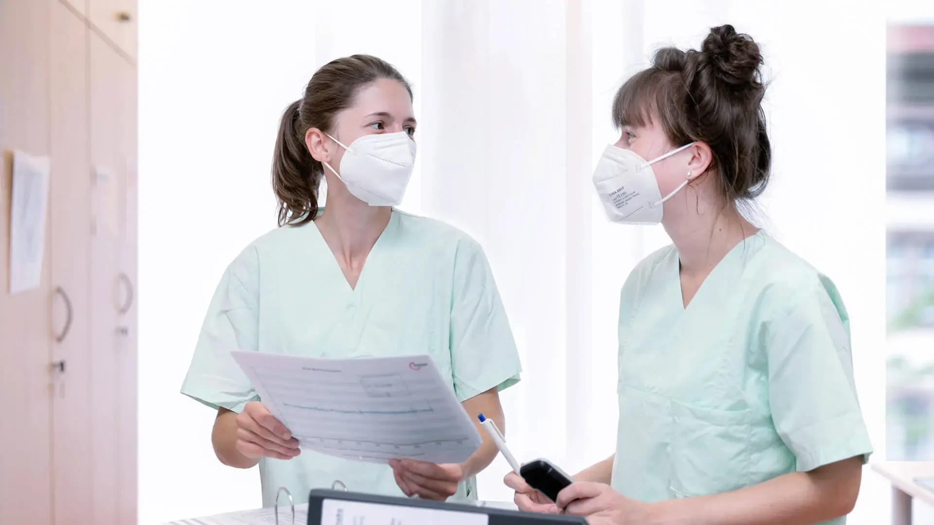 Zwei Mitarbeiterinnen im Austausch zu einer klinischen Studie