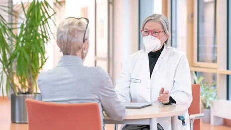Dr. Gerda Hofmann-Wackersreuther, Oberärztin, spricht mit einer Patientin der Palliativstation. 