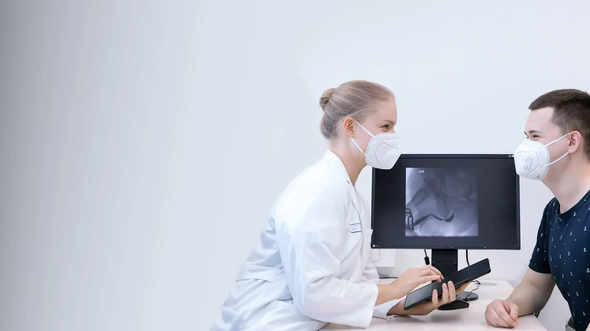 Eine Ärztin bespricht die nächsten Behandlungsschritte mit einem Patienten. 