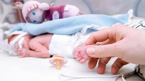 Frühgeborenes Baby liegt im Inkubator