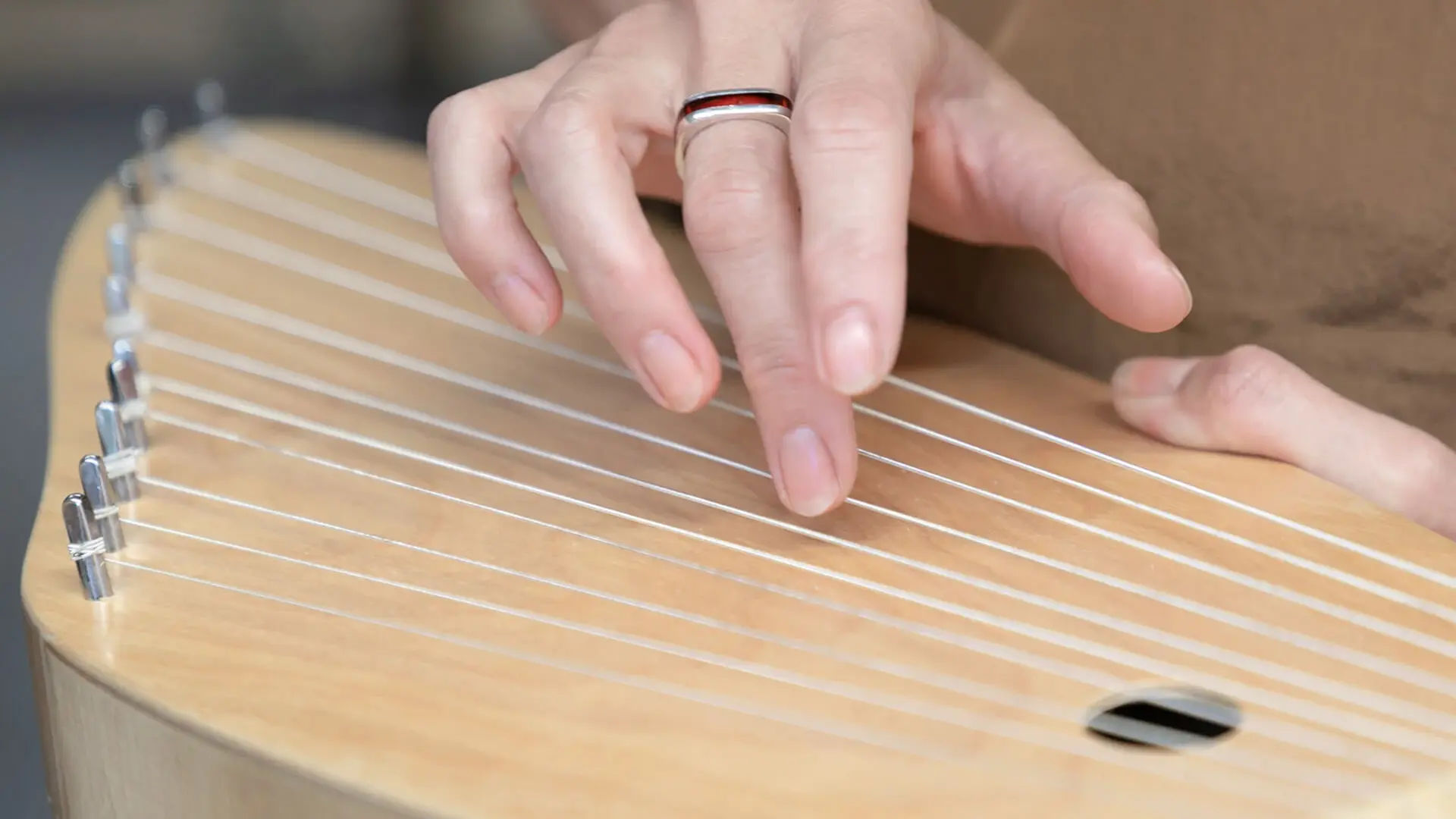 Eine Patientin spielt auf einer Kantele.