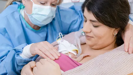 Frühgeborenes liegt auf der Brust der Mutter